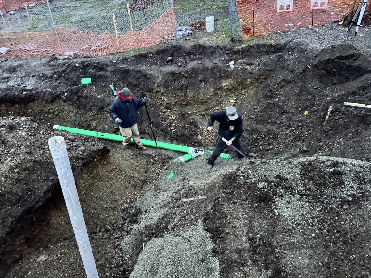HULK crew excavating and setting drainage pipe on a residential site